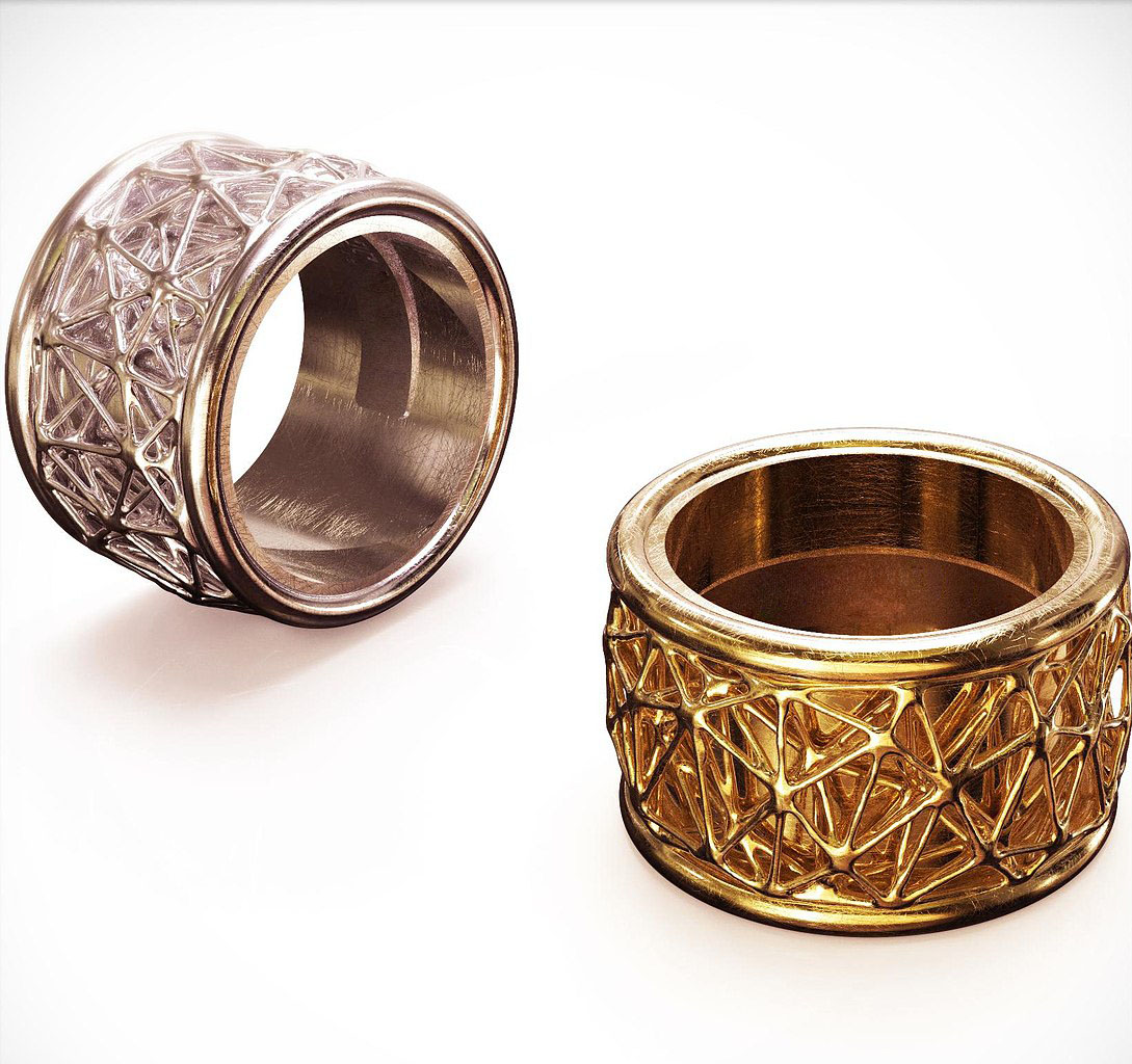 two cylindrical rings with texture, one silver, one gold 