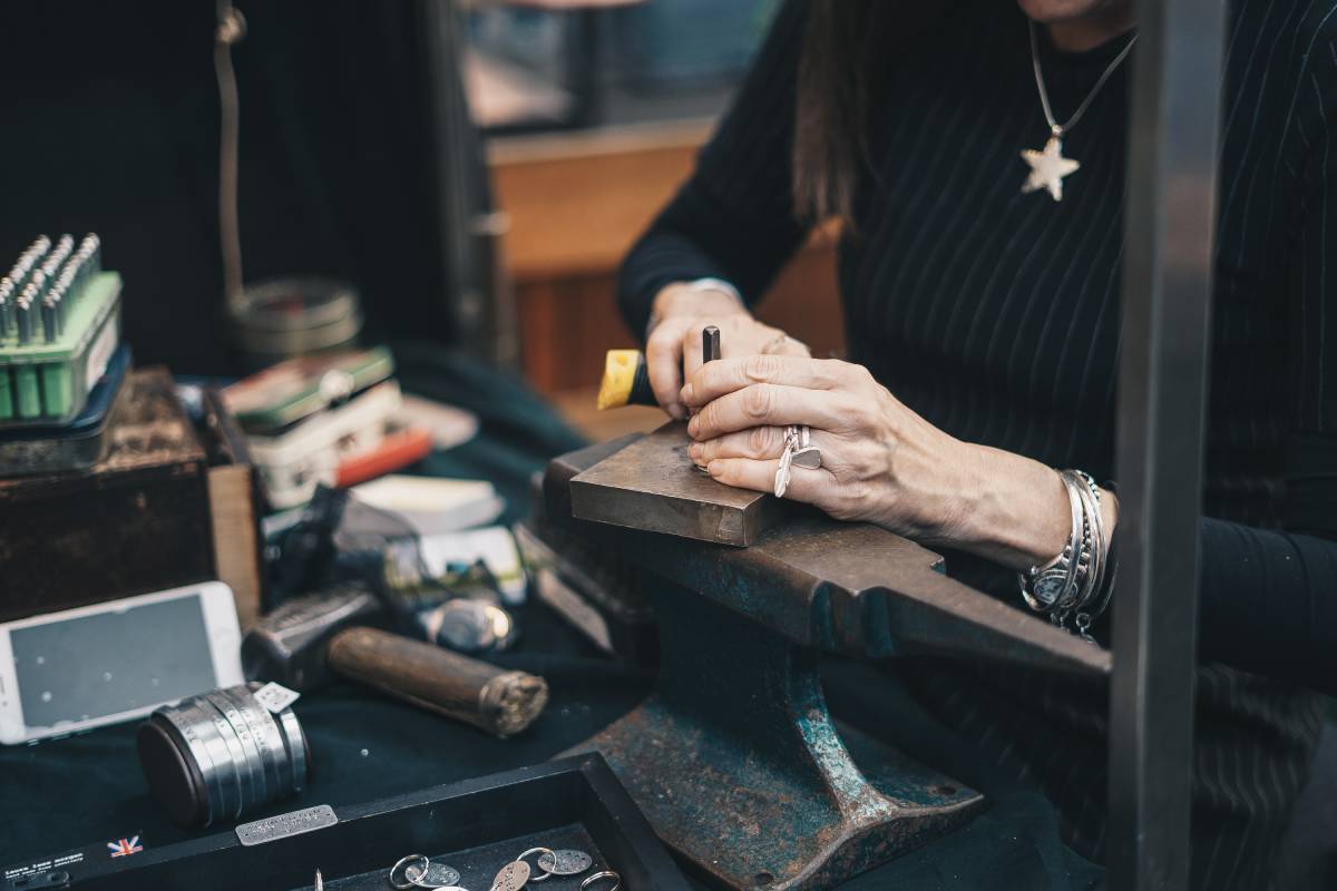 female jeweller using tools to create jewellery